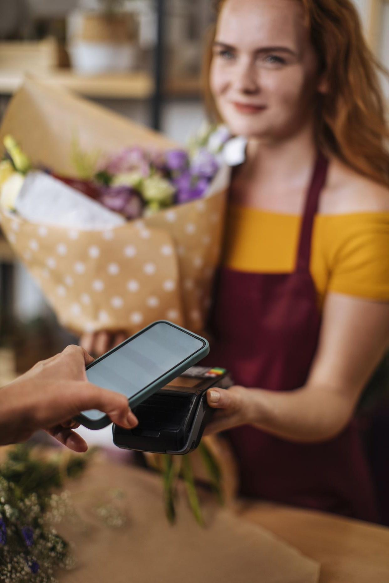Payment with phone in flower shop